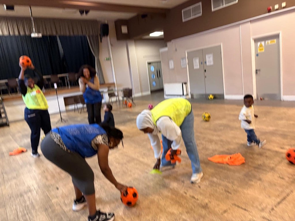 A Womenion football session in a community hall